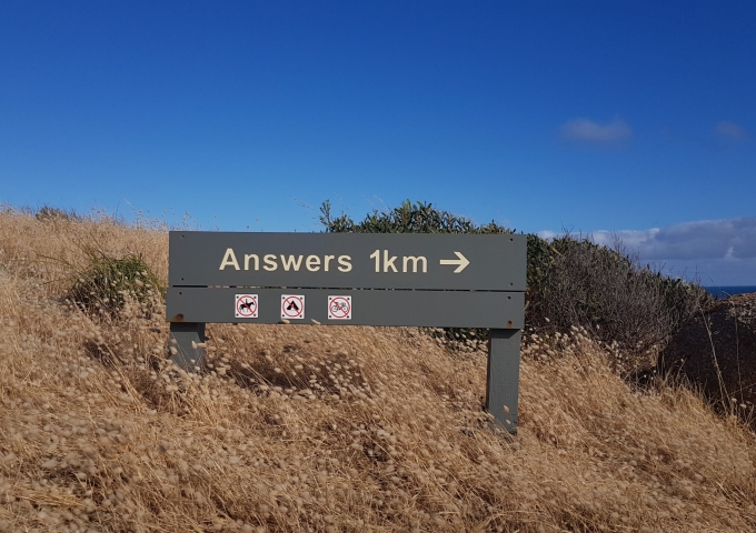 Straßenschild mit Aufschrift "Answers 1km"